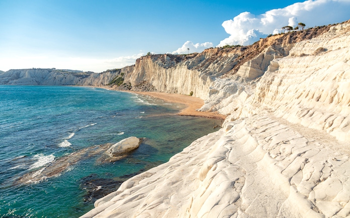 Scala dei Turchi limestone cliffs and turquoise sea on a minivan tour in Sicily, Italy.