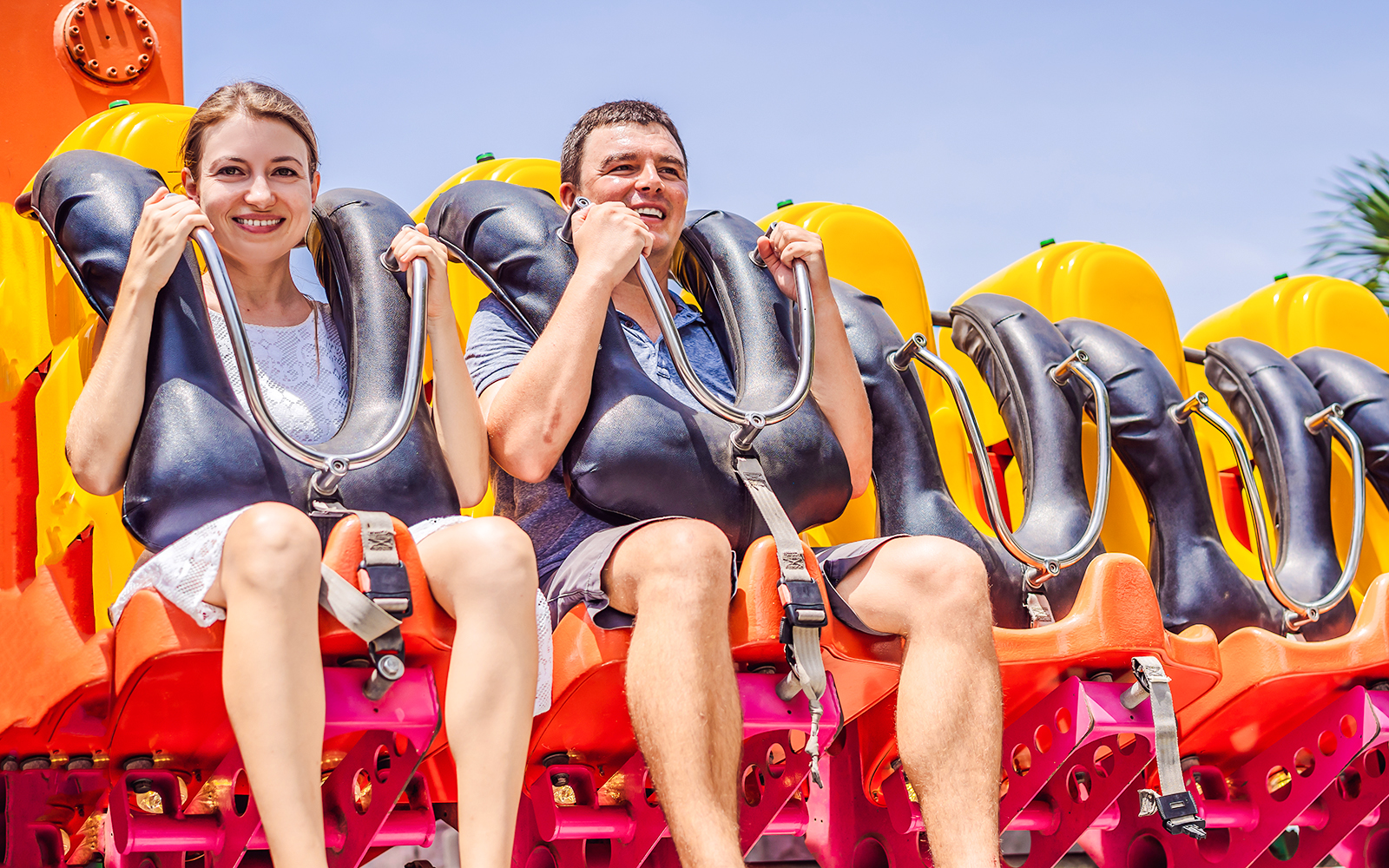 Friends enjoying a ride at an amusement park.