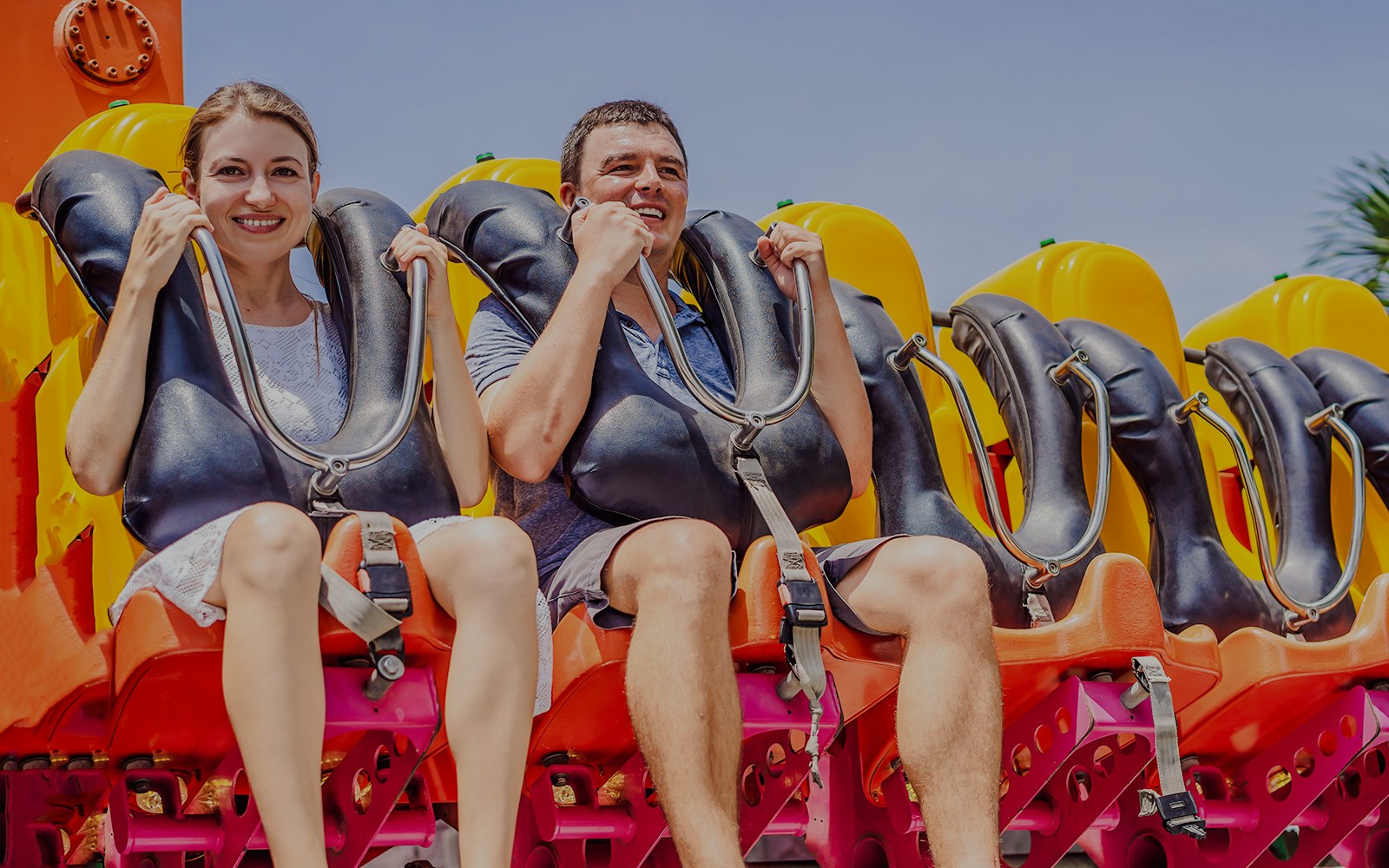 Friends enjoying a ride at an amusement park.