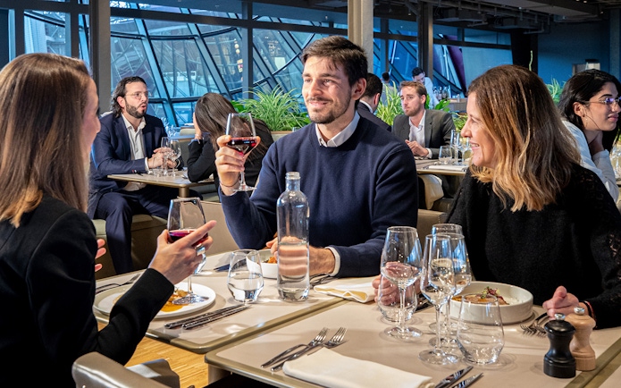 Tourists dining at a restaurant on the Eiffel Tower during a Paris day trip.