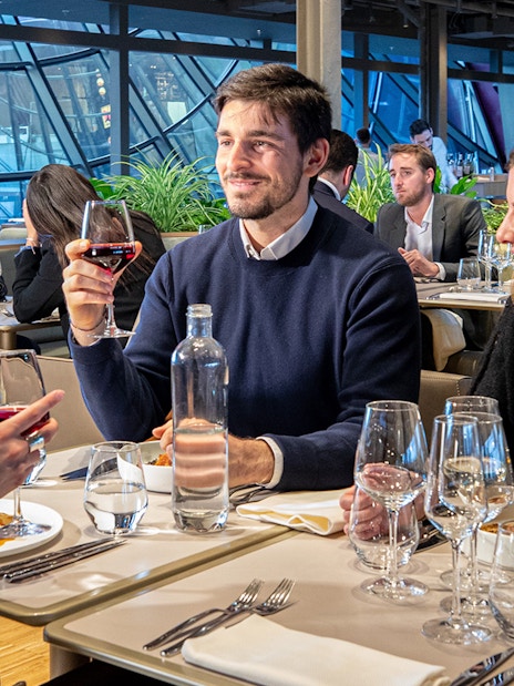 Tourists dining at a restaurant on the Eiffel Tower during a Paris day trip.