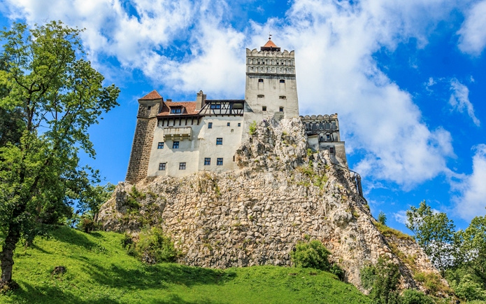 Bran Castle with medieval architecture on a rocky hill in Transylvania, Romania.