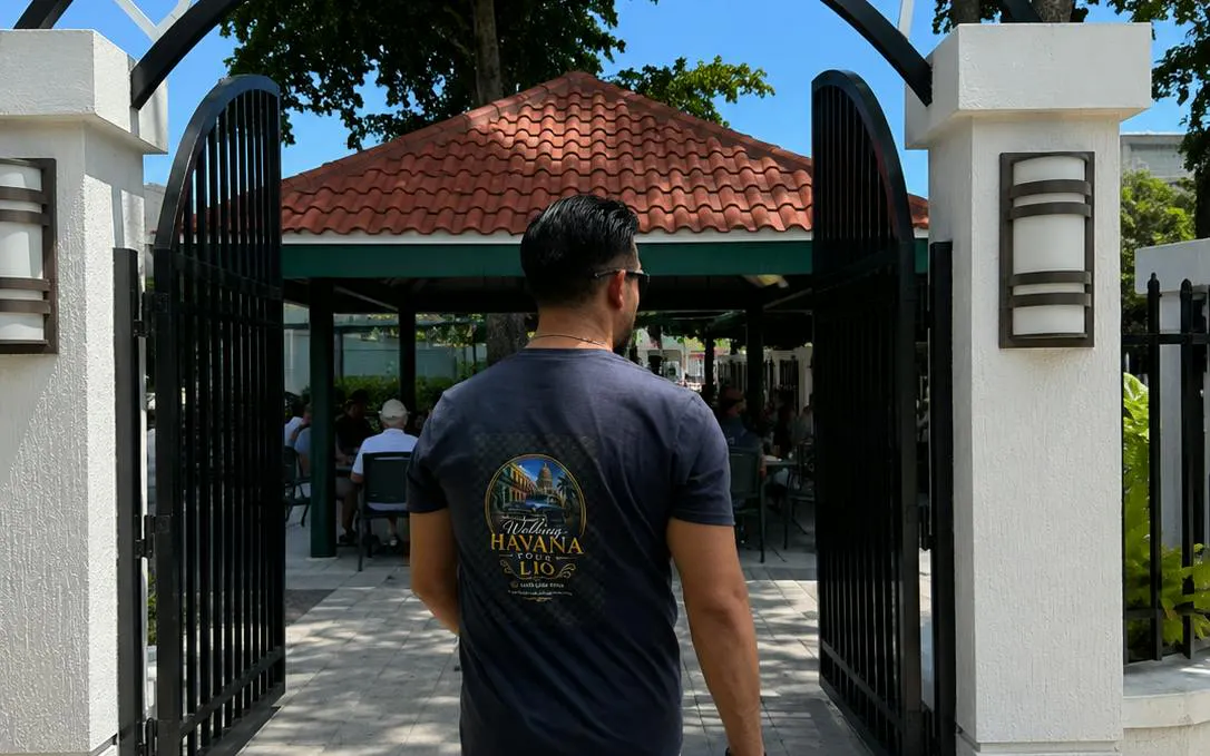Man entering a courtyard in Little Havana, Miami, during a food and culture walking tour.