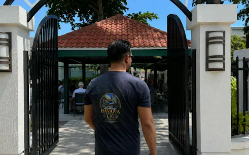 Man entering a courtyard in Little Havana, Miami, during a food and culture walking tour.