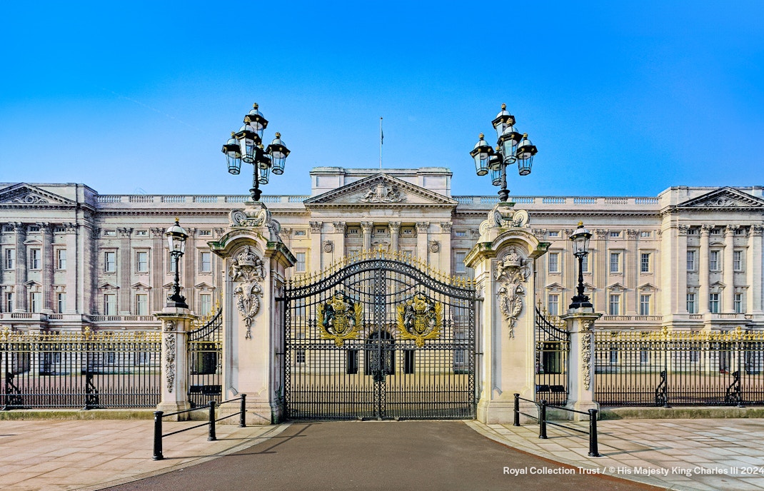 Buckingham Palace guards in red uniforms marching during Changing of the Guard, London.