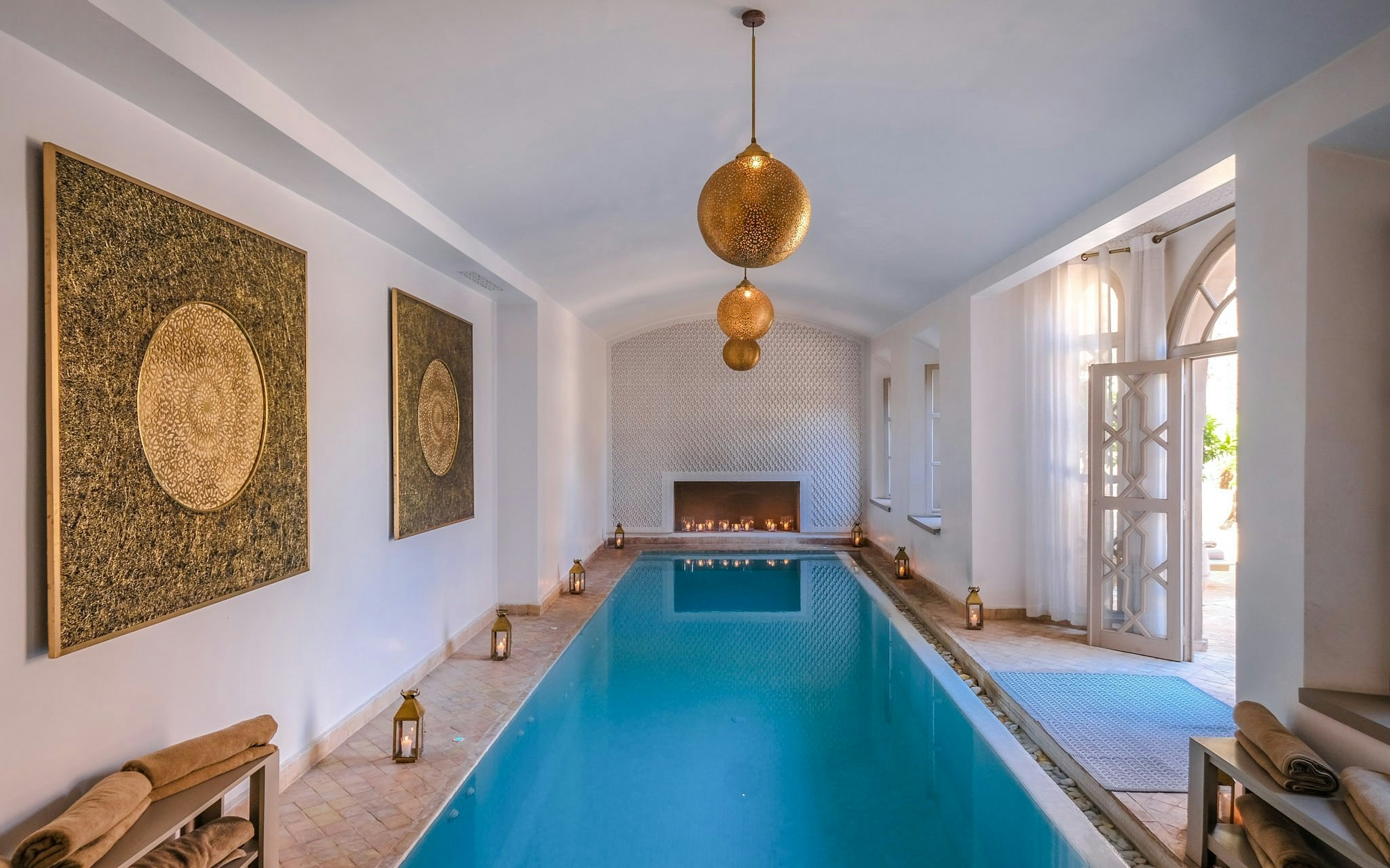 Luxurious indoor pool with lanterns and ornate decor at a steam hammam spa.