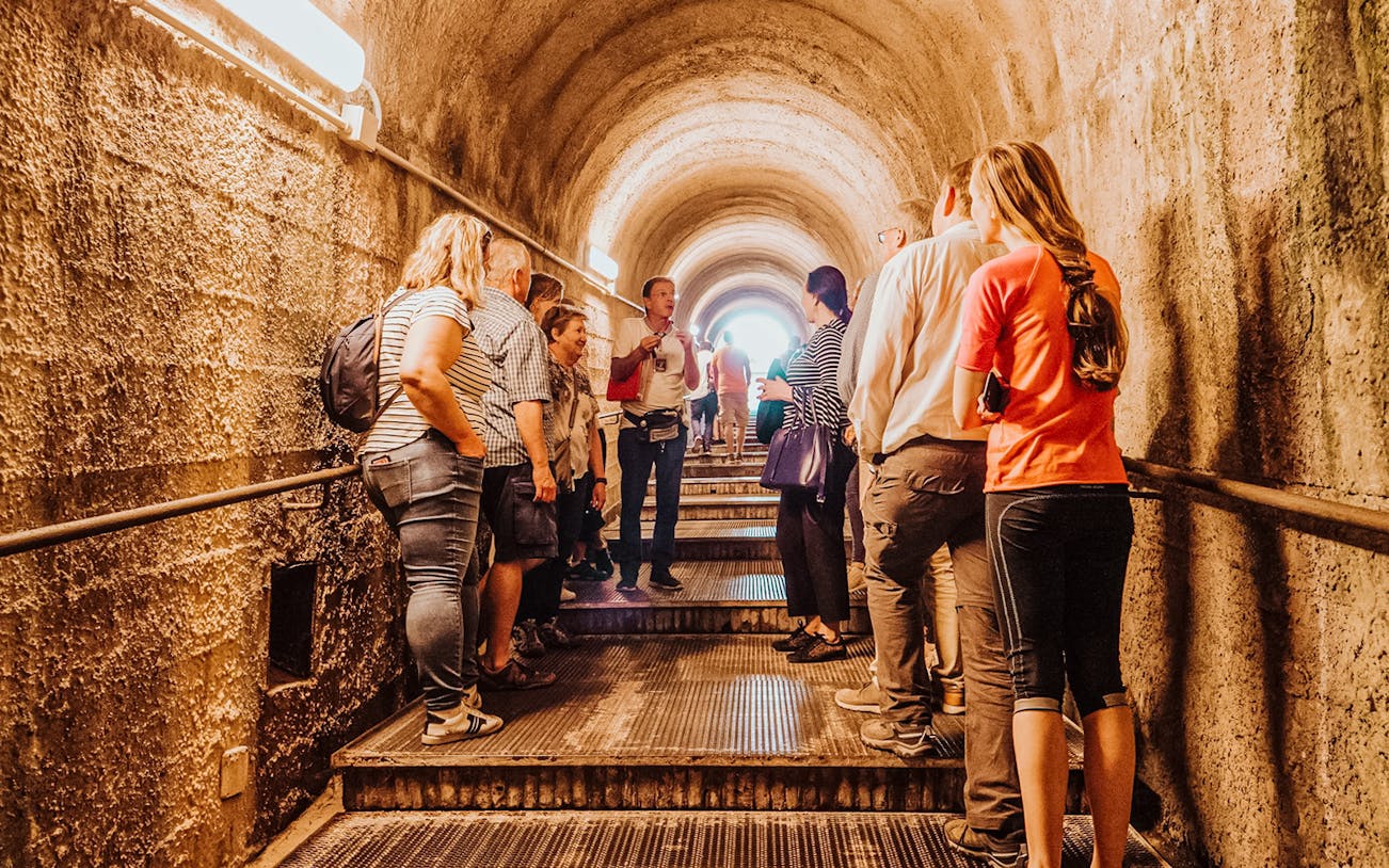 Tour group with guide in Pompeii tunnel, Italy.