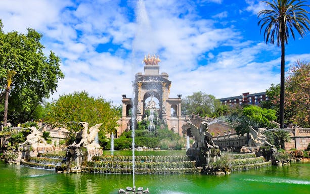 Cascada Monumental fountain in Barcelona's Parc de la Ciutadella, surrounded by greenery.
