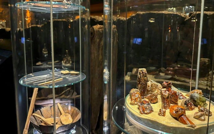 Artifacts displayed in glass cases at Rynek Underground Museum, Krakow.