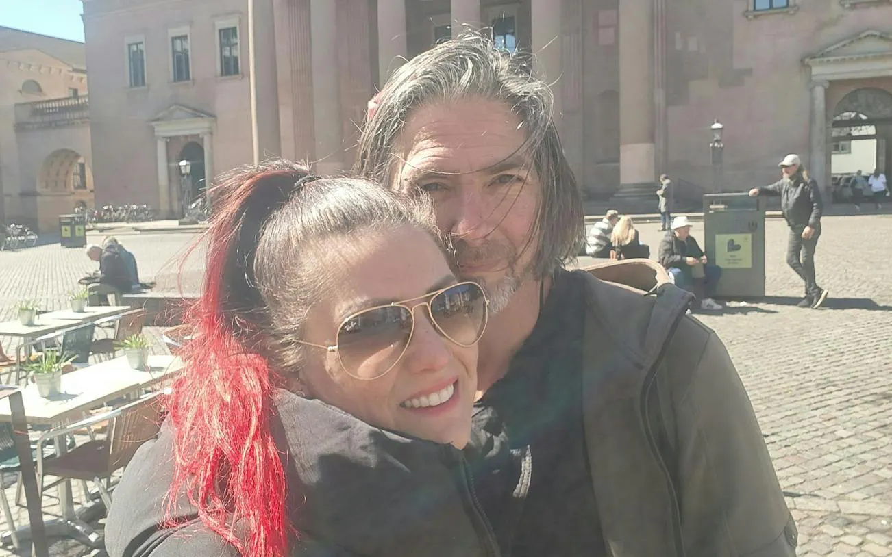 Couple enjoying a sunny day in a Copenhagen square during the Time Travelers Cronophone city exploration game.