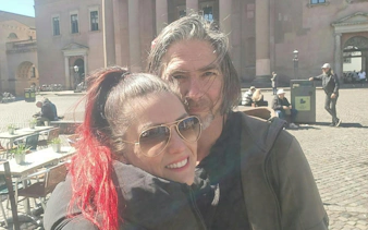Couple enjoying a sunny day in a Copenhagen square during the Time Travelers Cronophone city exploration game.