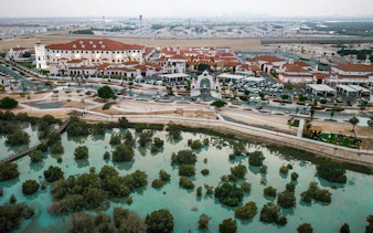 Aerial view of Abu Dhabi Royal Equestrian Arts complex with surrounding landscape.