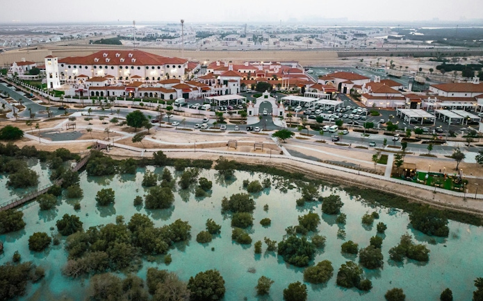 Aerial view of Abu Dhabi Royal Equestrian Arts complex with surrounding landscape.