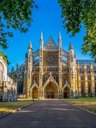 Westminster Abbey exterior with tourists in London.