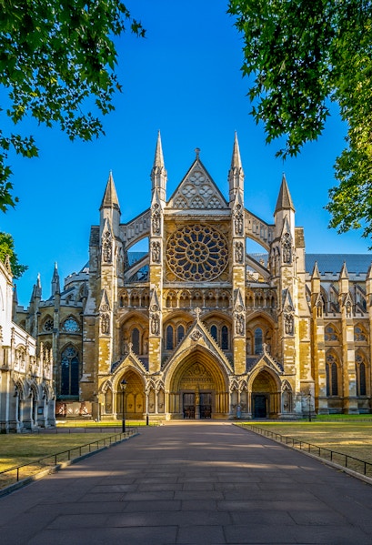 Westminster Abbey exterior with tourists in London.