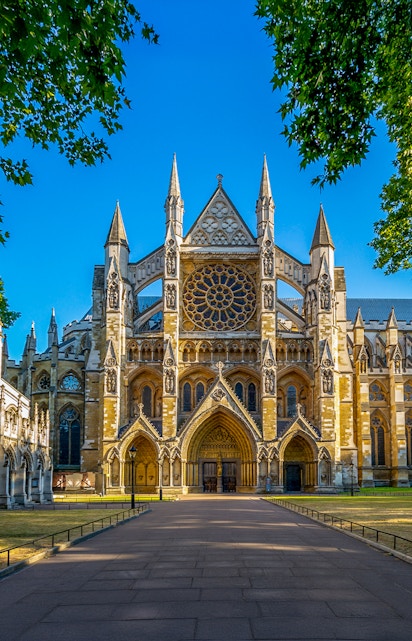 Westminster Abbey exterior with tourists in London.