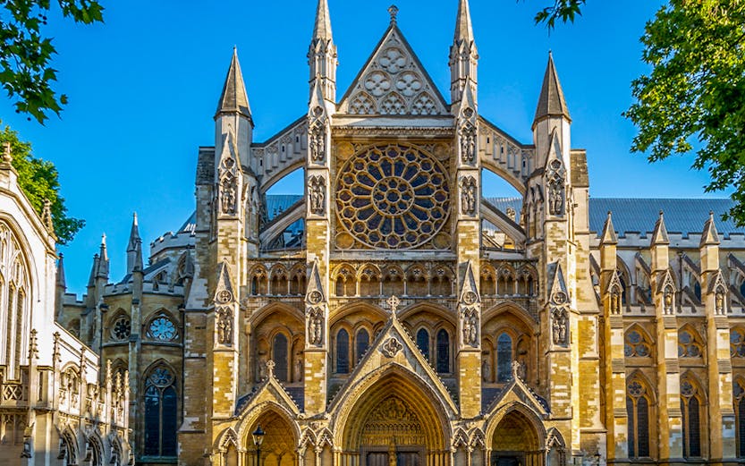 Westminster Abbey exterior with tourists in London.