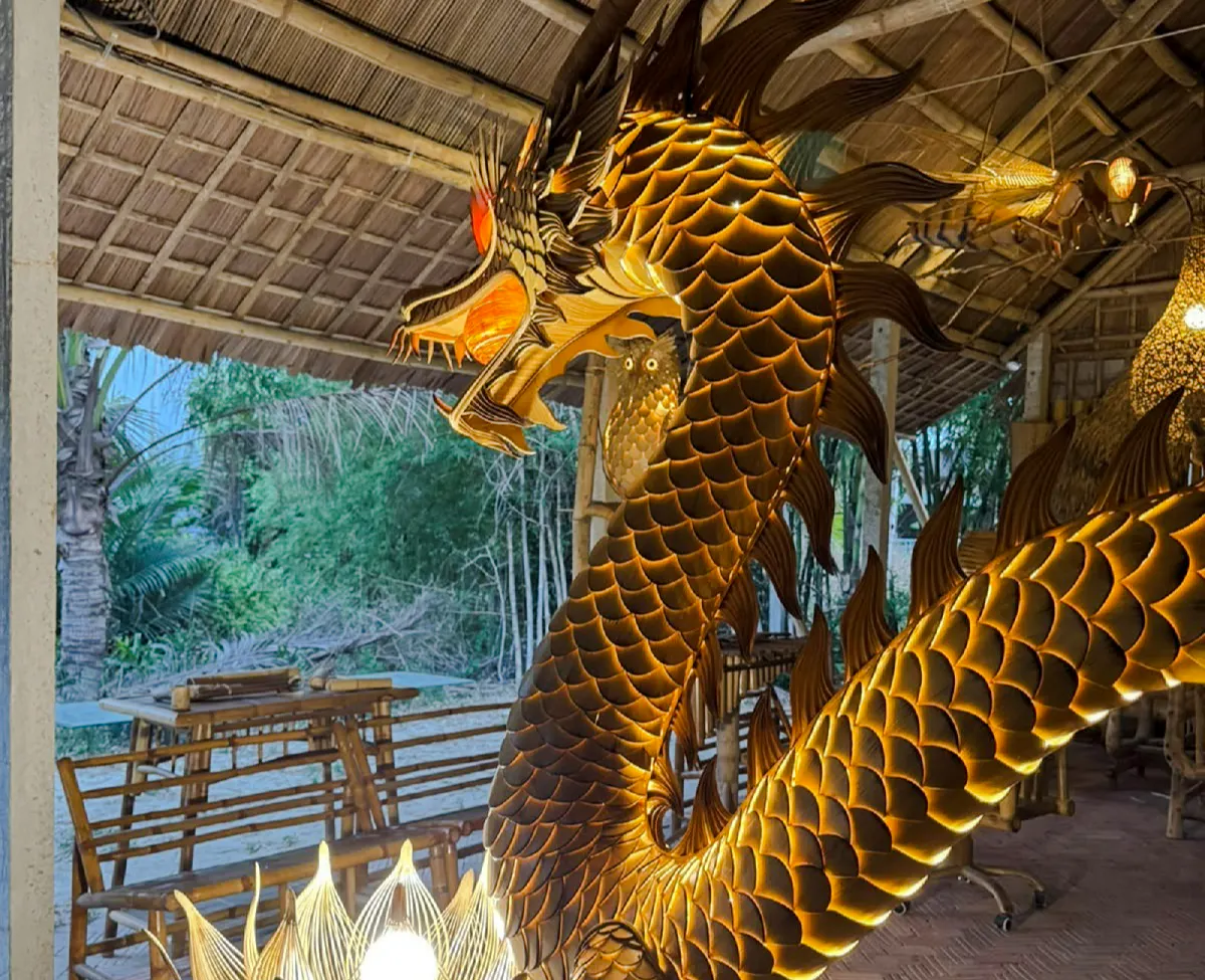 Bamboo dragon sculpture in Hoi An workshop showcasing local craft and sustainability.