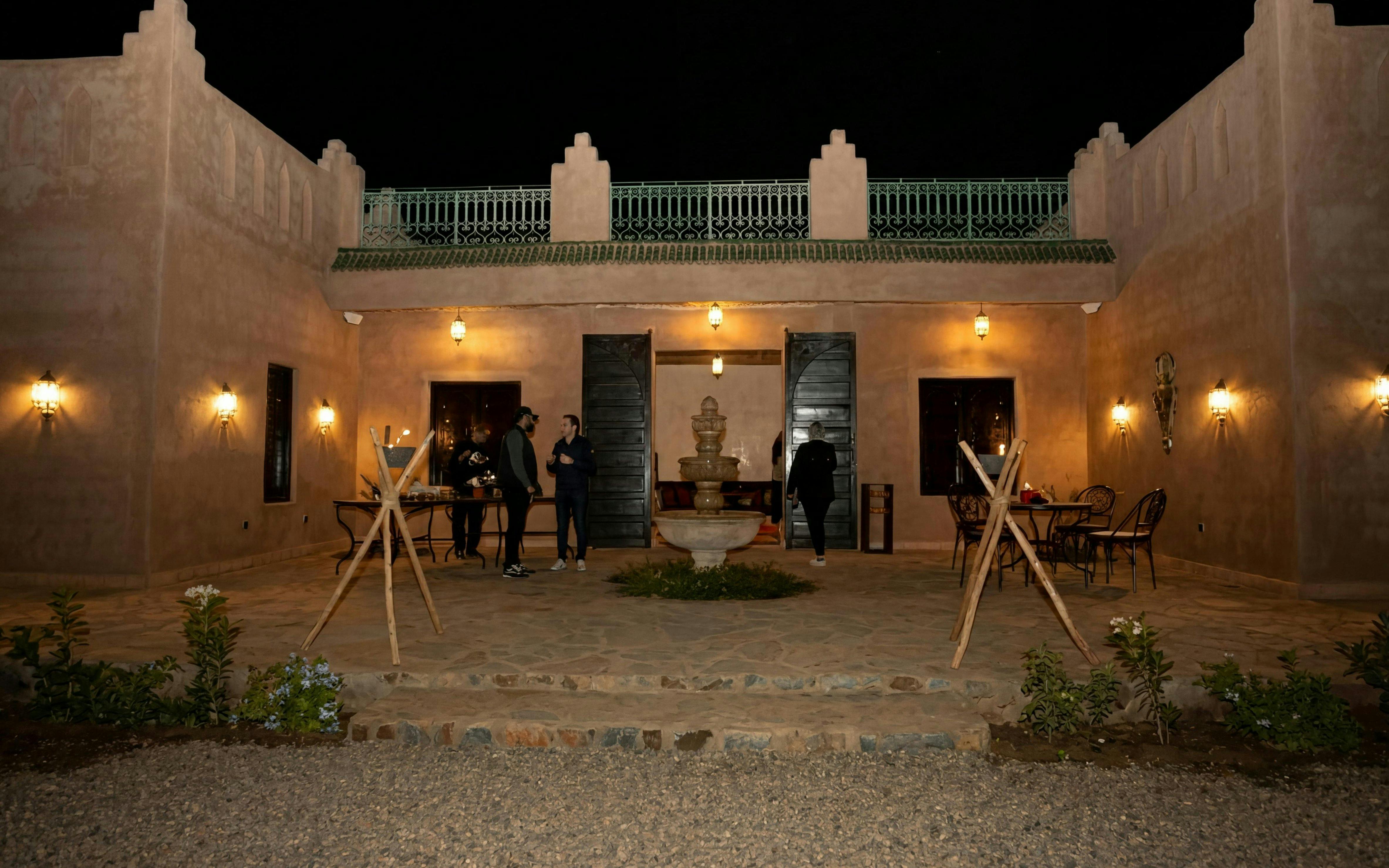 Courtyard of a traditional Moroccan building at night, Marrakech tour.