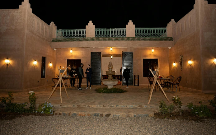 Courtyard of a traditional Moroccan building at night, Marrakech tour.