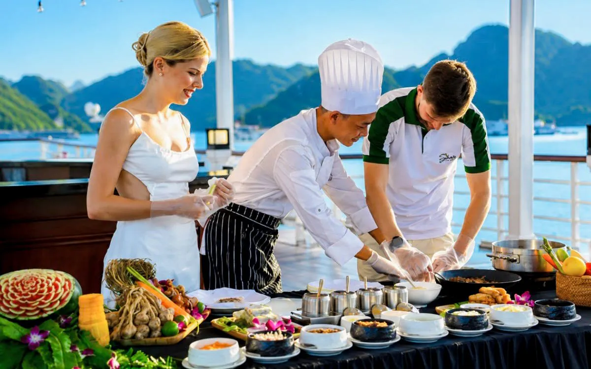 Chef leading cooking class on Ha Long Bay 5-Star Premium Cruise with scenic view.