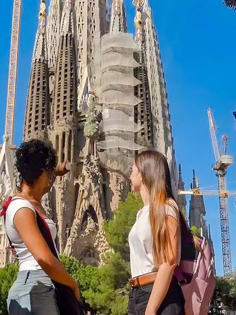 Tour group observing Sagrada Familia exterior in Barcelona.
