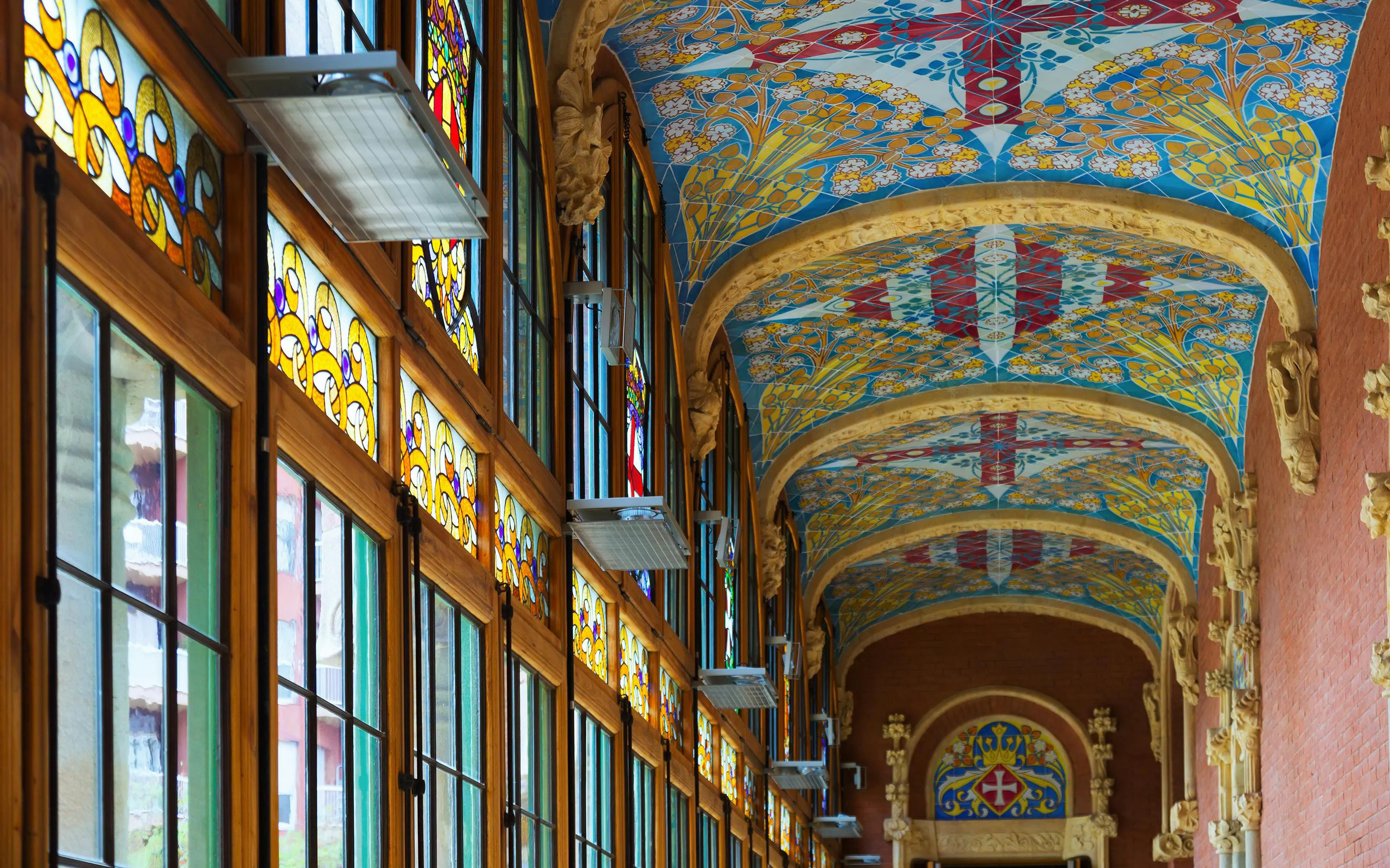 Stained glass windows and ornate ceiling in Hospital de la Santa Creu i Sant Pau, Barcelona.