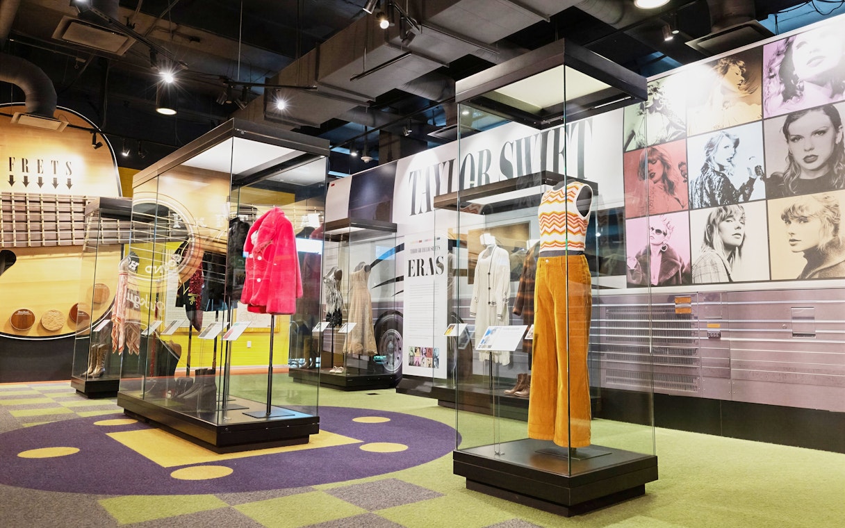 Taylor Swift outfits on display at the Country Music Hall of Fame and Museum exhibition.