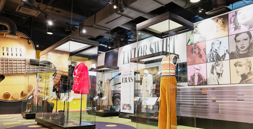 Taylor Swift outfits on display at the Country Music Hall of Fame and Museum exhibition.