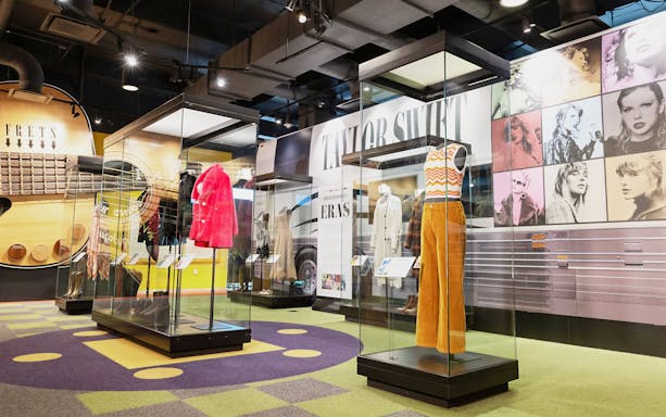 Taylor Swift outfits on display at the Country Music Hall of Fame and Museum exhibition.
