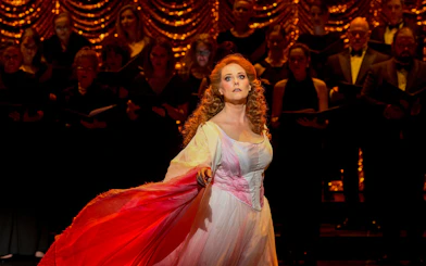 Performer in a scene from "My Fair Lady" with a choir in the background.