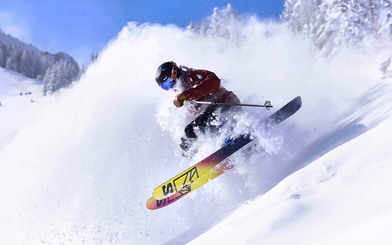 Skier navigating powder snow on a mountain slope, Ikon Pass multi-resort access.