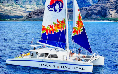Sailing catamaran on West Oahu waters during whale watching tour.