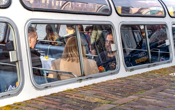 Passengers inside a canal boat during Haarlem sightseeing cruise.