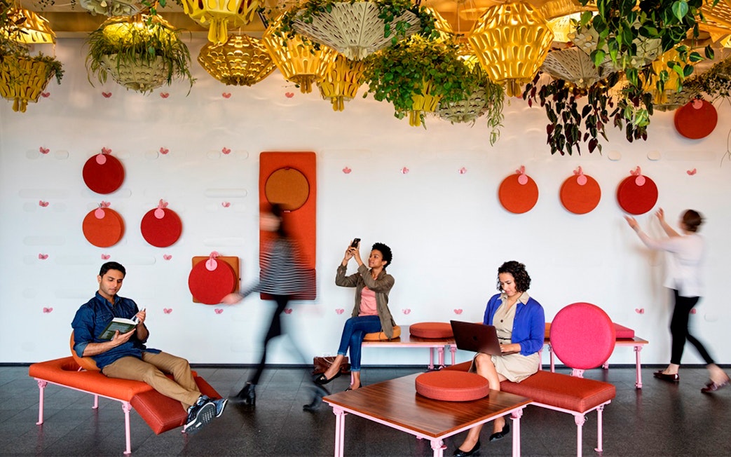 People relaxing and working in a modern lounge with colorful decor in Chicago.