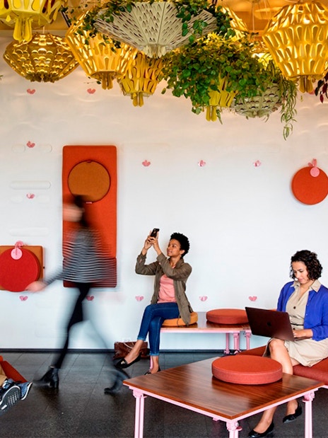 People relaxing and working in a modern lounge with colorful decor in Chicago.