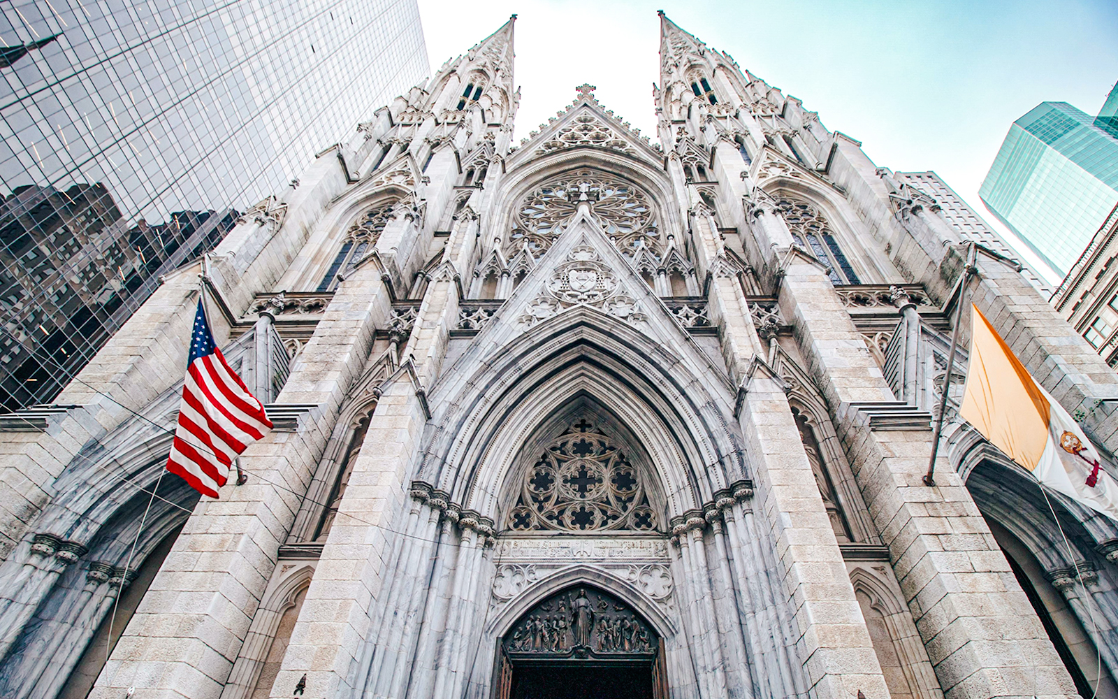 St. Patrick's Cathedral Gothic Revival facade, New York City, with American flag.