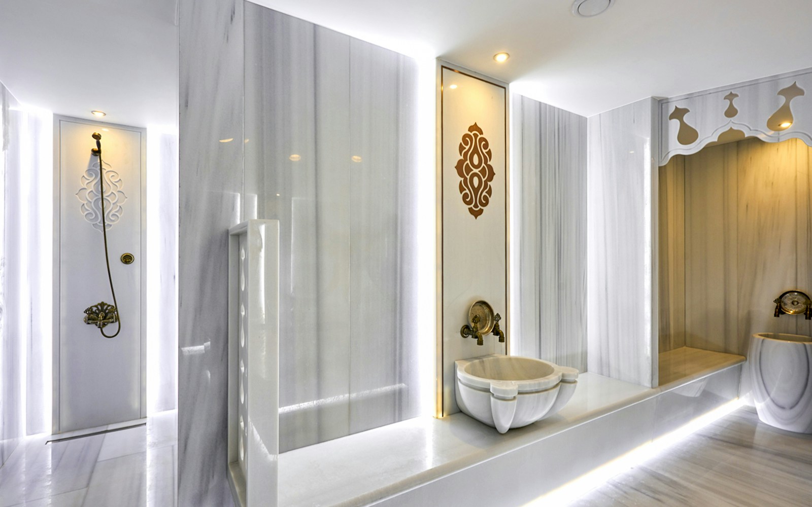 Turkish bath interior with marble basins and massage tables in Istanbul spa.