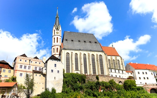 Saint Vitus church exterior with clock tower in Cesky Krumlov, Czech Republic.