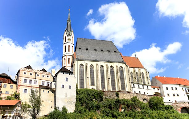 Saint Vitus church exterior with clock tower in Cesky Krumlov, Czech Republic.