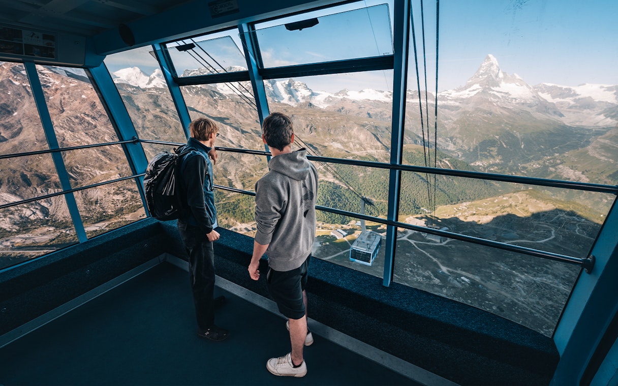 Tourists inside cable car with view of Matterhorn Glacier, Switzerland.