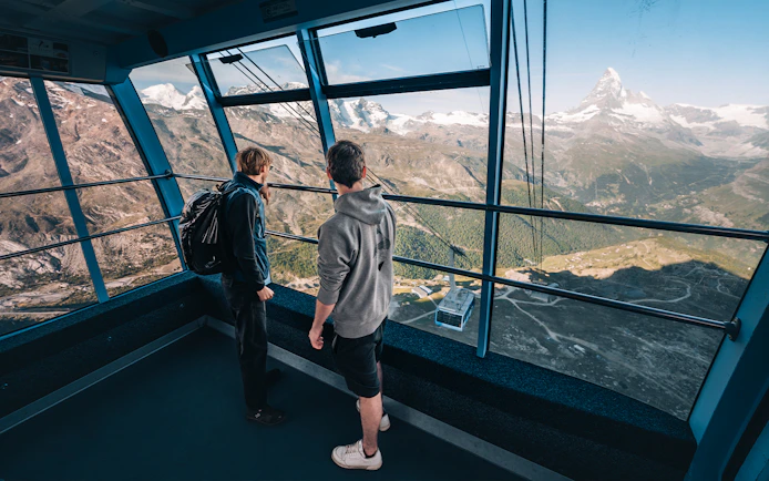 Tourists inside cable car with view of Matterhorn Glacier, Switzerland.