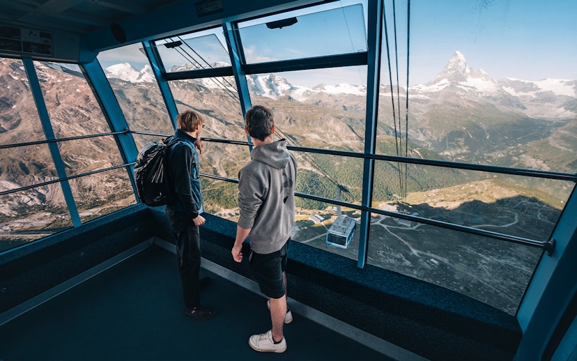 Tourists inside cable car with view of Matterhorn Glacier, Switzerland.