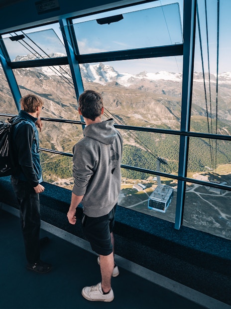 Tourists inside cable car with view of Matterhorn Glacier, Switzerland.