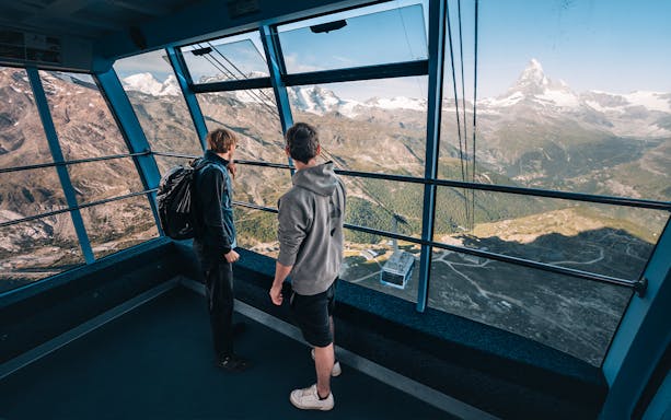 Tourists inside cable car with view of Matterhorn Glacier, Switzerland.
