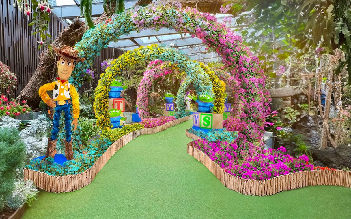 Colorful floral arches with character sculptures at Gardens by the Bay's Floral Fantasy, Singapore.