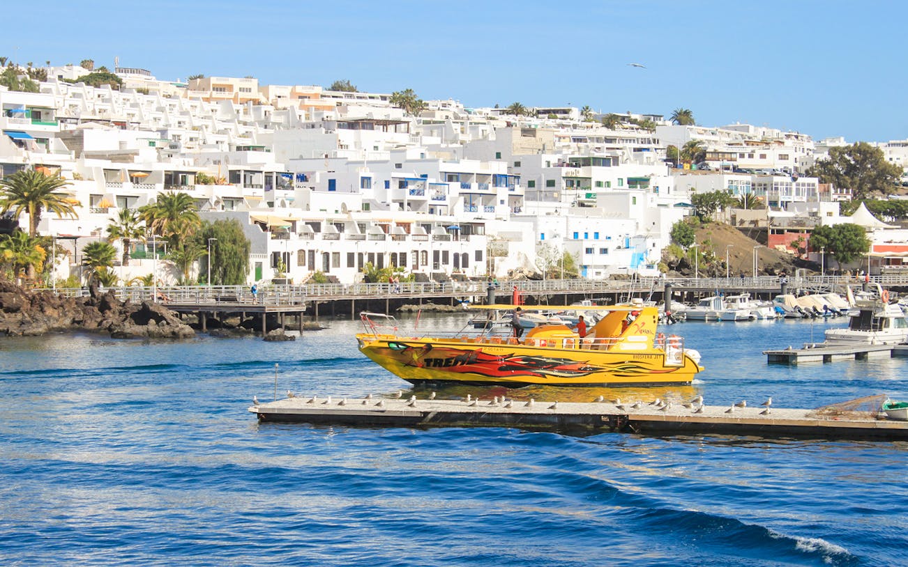 Tourist boat departing from Lanzarote port for dolphin watching.