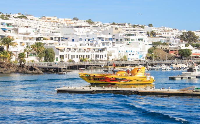 Tourist boat departing from Lanzarote port for dolphin watching.