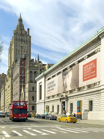 New York Historical Society building with exhibition banners and city street.