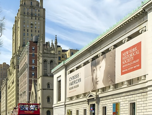New York Historical Society building with exhibition banners and city street.